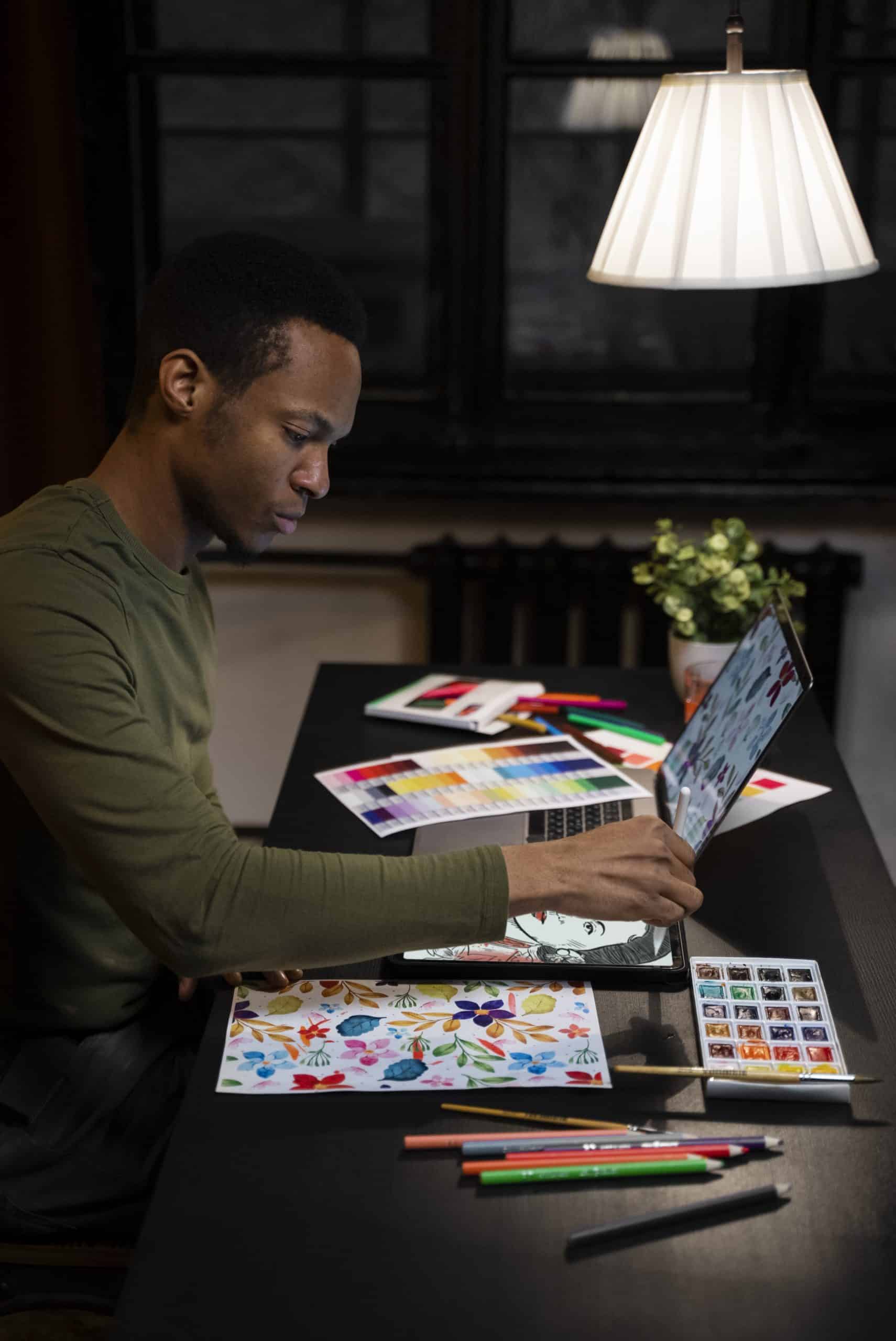 Designer using digital drawing tablet for creative branding work | Trident Media Management